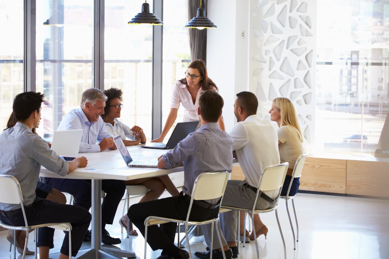 A small business team meeting around a conference table, the kind of team that books a wellness morning at Prime IV Hydration & Wellness in Huntsville